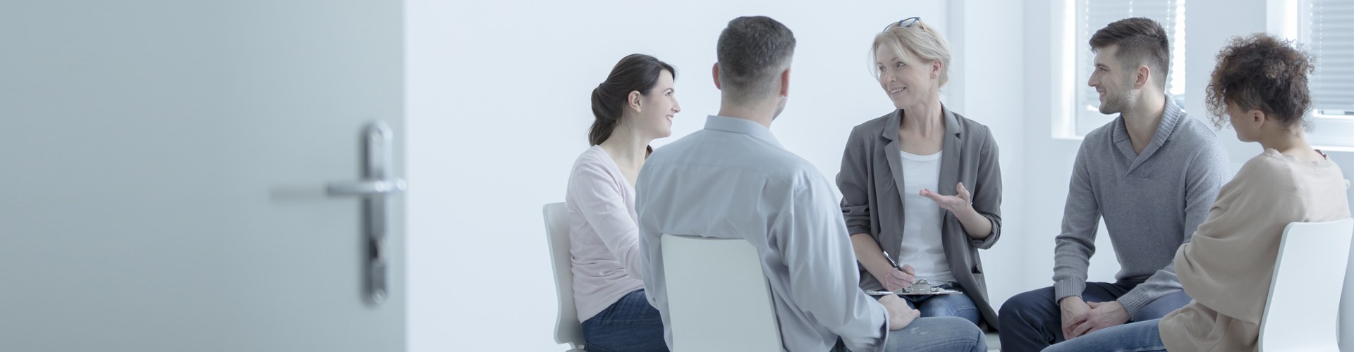 Close-up of psychotherapist listening to patient with anxiety disorder during group session